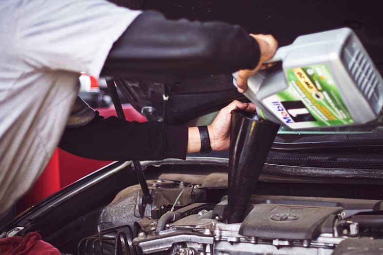 Man Refilling Motor Oil