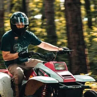 Man Riding ATV in Forest During the Day