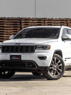 White Jeep Grand Cherokee SUV near Stacked Brown Pallet Boards