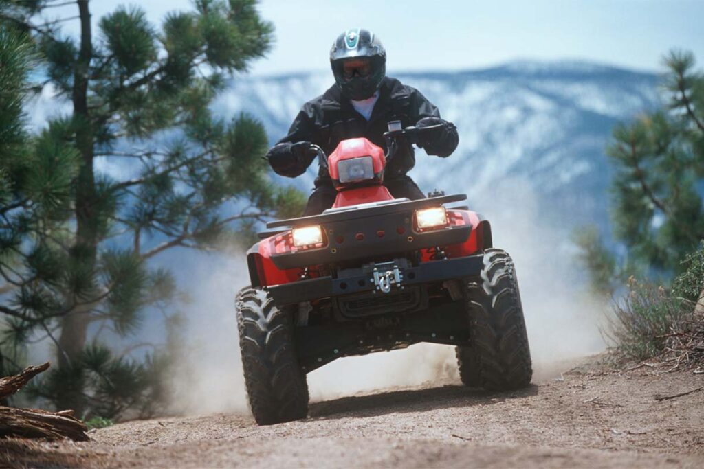 ATV Traveling Down a Dusty Mountain Trail
