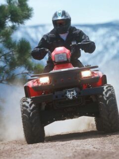 ATV Traveling Down a Dusty Mountain Trail