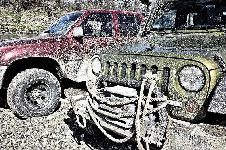 Two Muddy Off-Road Vehicles