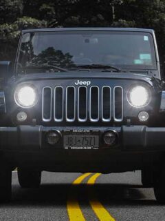 Black Jeep Wrangler Driving on Paved Road