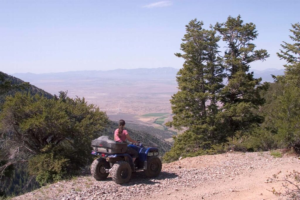 Blue ATV on Dirt Trail Around Scenery