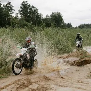 Dirt Bike Riding Through Muddy Trail