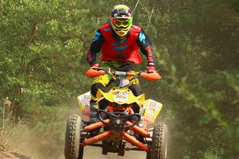 ATV Rider with Red Shirt Driving Yellow Quad