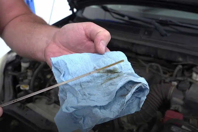Checking Car Oil with Cloth and Dipstick