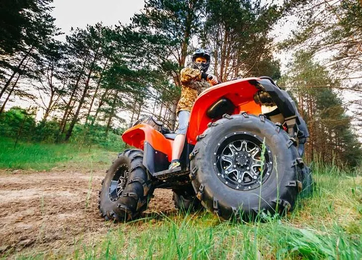 Man on ATV Quad Bike in Mud Track