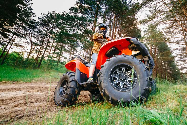 Man on ATV Quad Bike in Mud Track