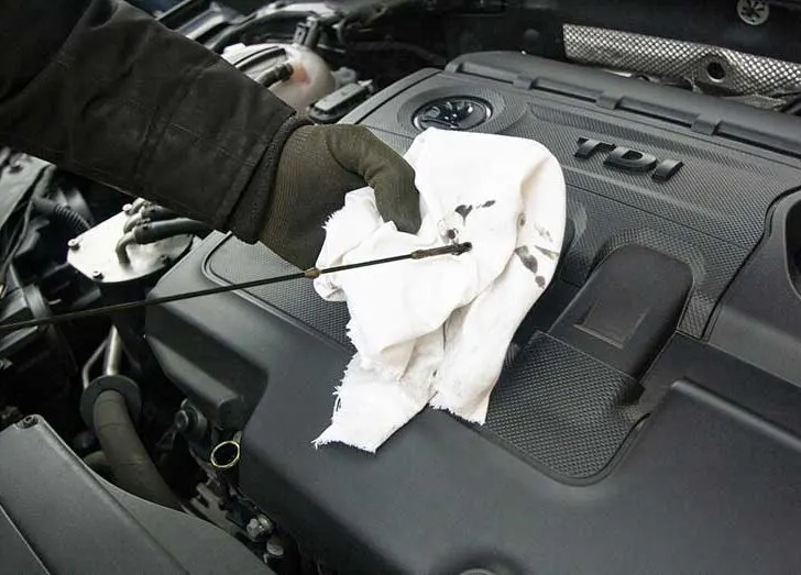 Checking Motor Oil with Dipstick and Cloth