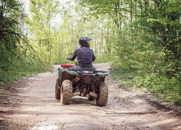 Person Riding ATV Bike on Mountain Trail