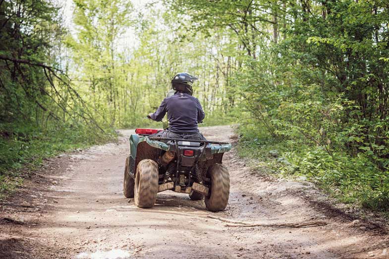 Person Riding ATV Bike on Mountain Trail