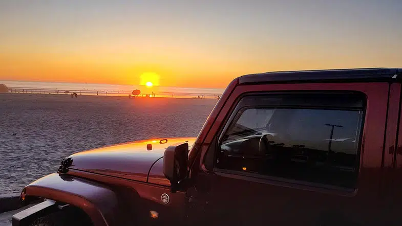 Red Jeep on the Beach During Sunset