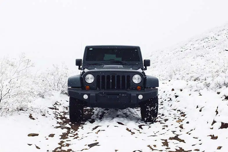 Black Jeep Wrangler Off-Road Snow Trail
