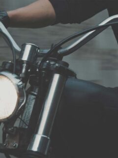 Person Riding Motorbike with Headlight on