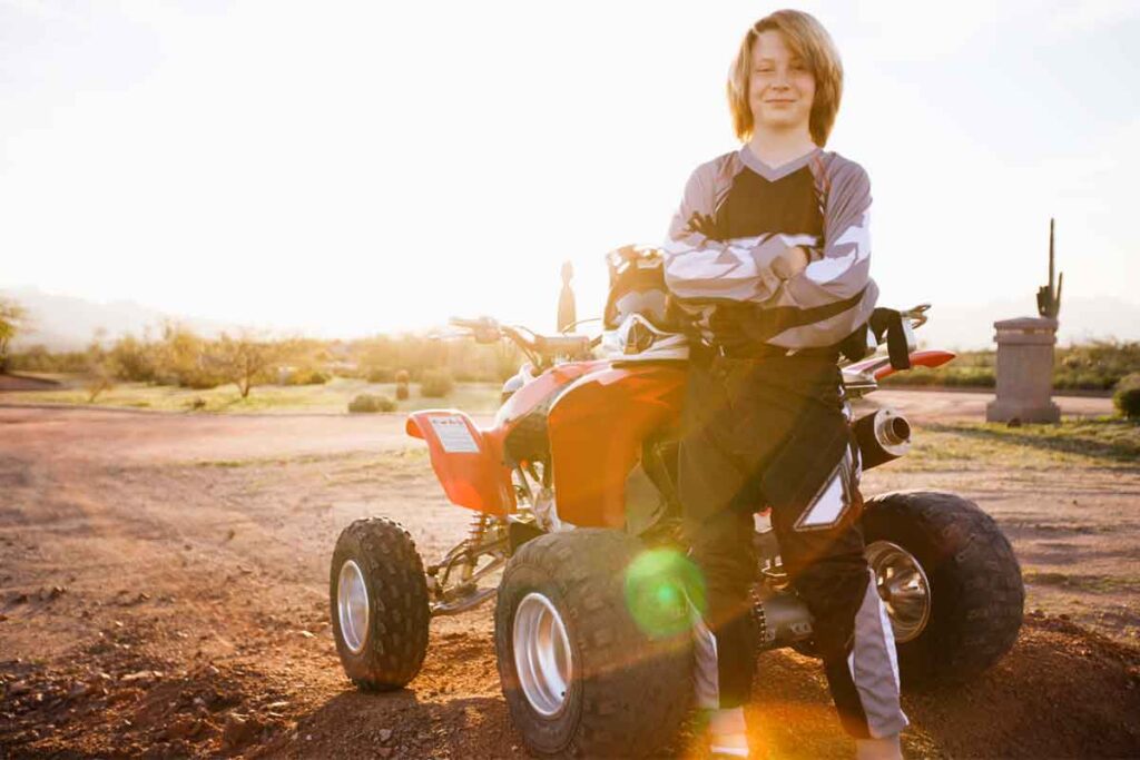 Boy Beside Red ATV