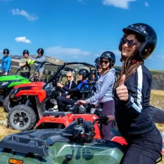 Group of People Riding Quads Off-Road