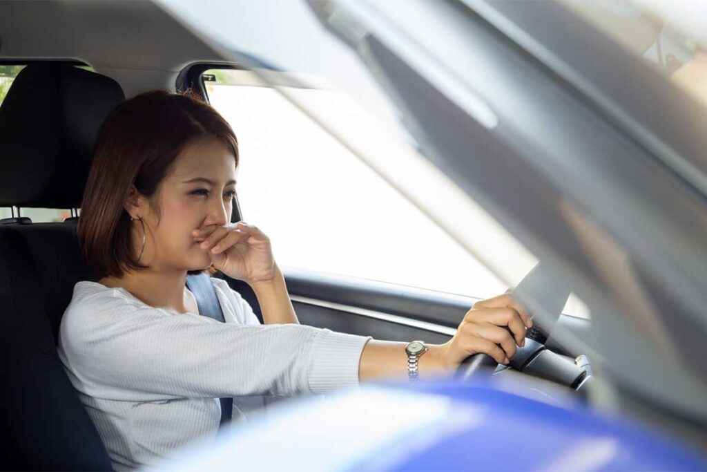 Person Holding Nose Because of Bad Smell in Car