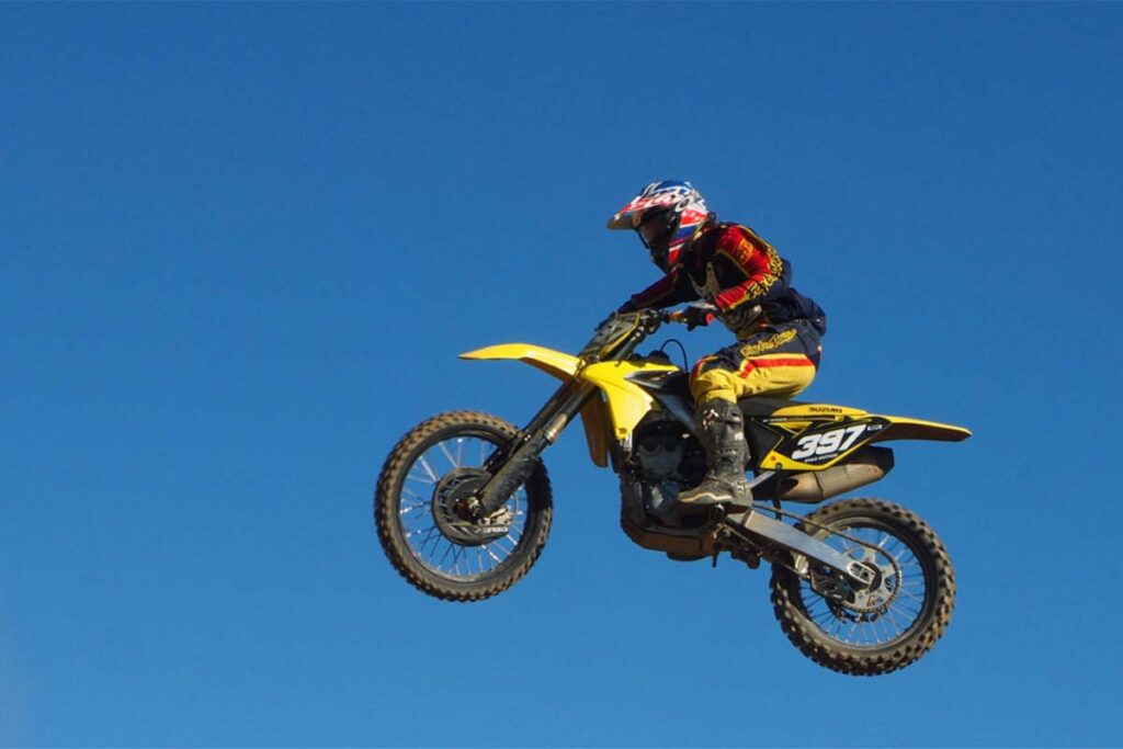 Person Riding Yellow Motocross Dirt Bike