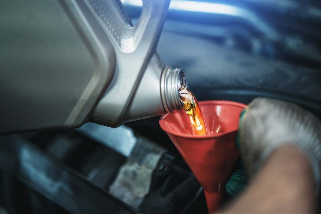 Worker Pouring Synthetic Motor Oil