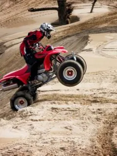 Red ATV Jumping Sand Dunes