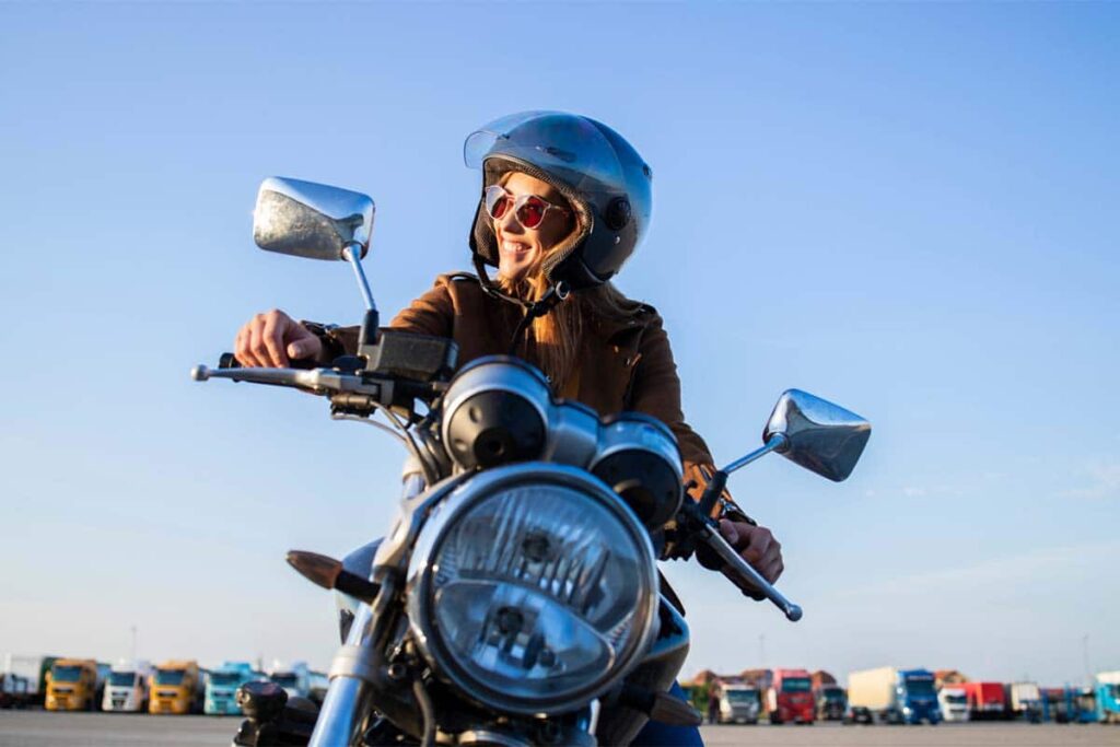 Female Motorbike Rider Wearing Helmet