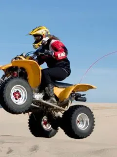 Yellow ATV Sand Dune Jumping