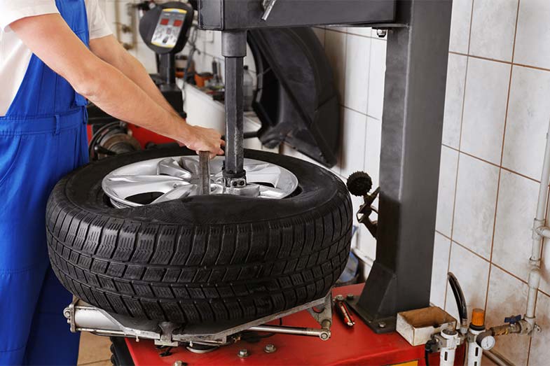 Mechanic Mounting a Tire on a Rim