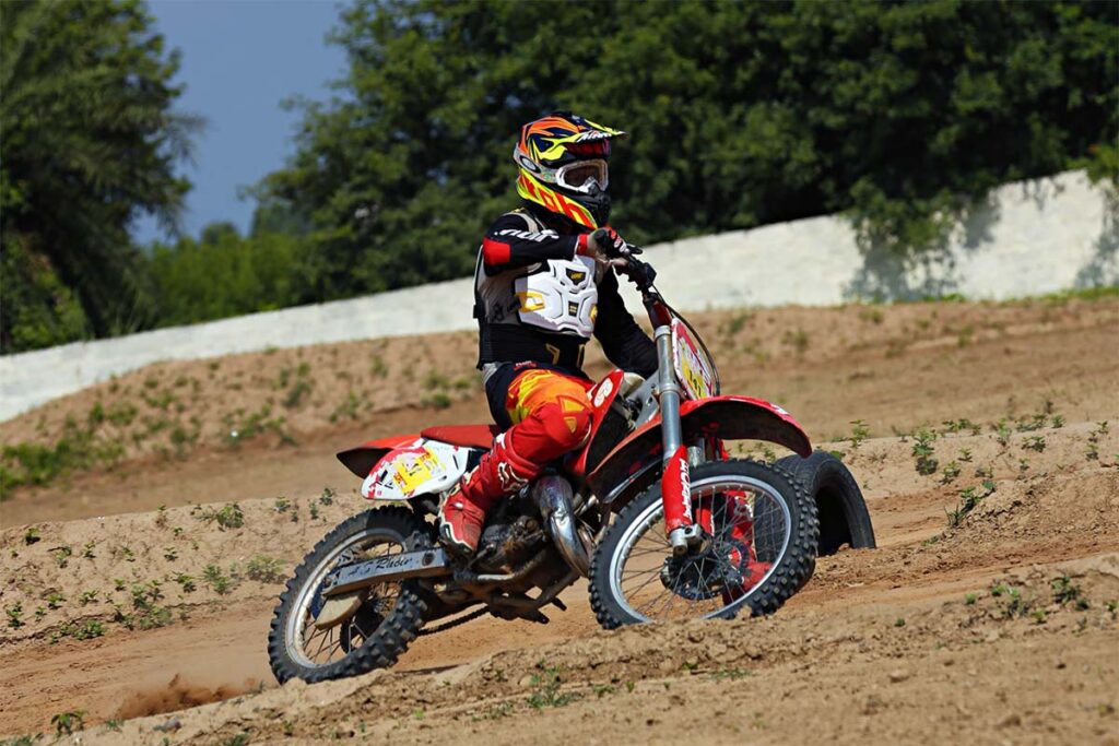 Person Riding Red Dirt Bike