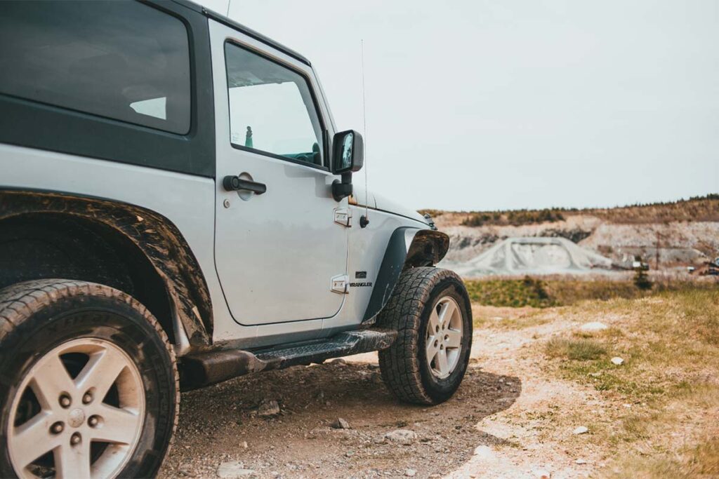 White and Black Jeep Wrangler on Brown Field