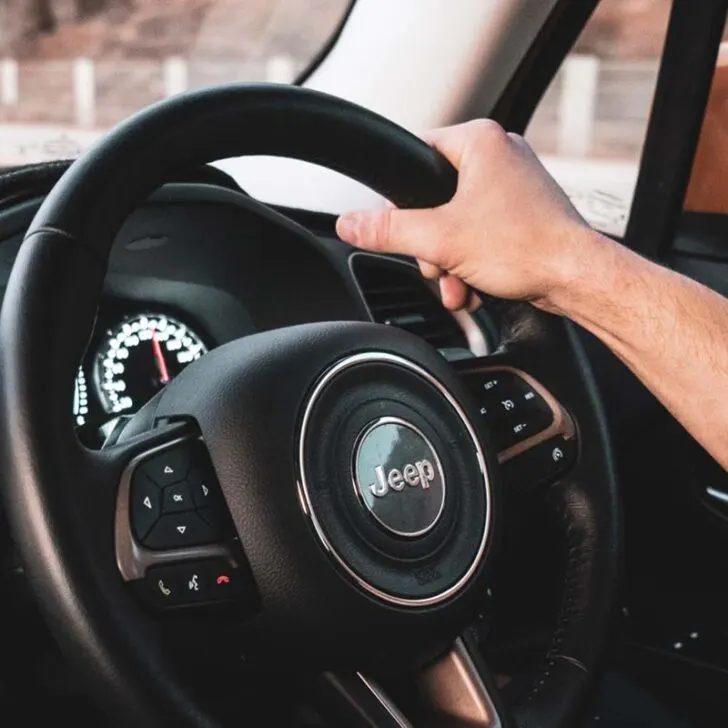 Person's Hand on Jeep Steering Wheel