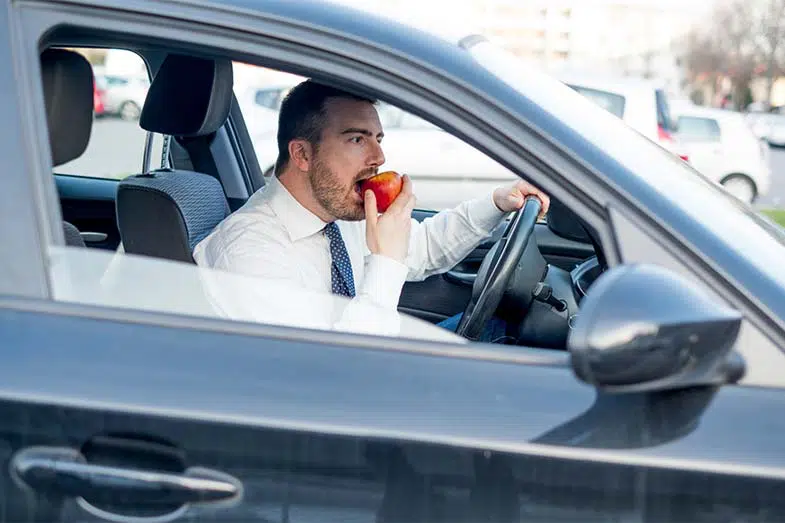 Person Eating Apple in Car