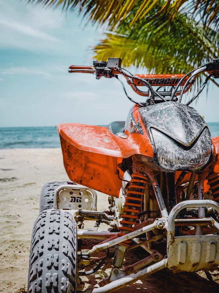 Red Honda Sportrax ATV on a Sandy Beach