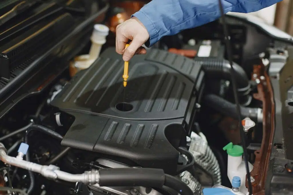 Person Checking Engine Oil Level