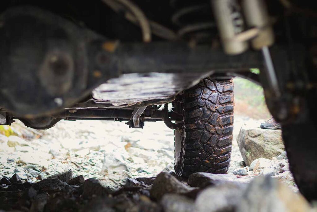 Jeep Underside Showing Wet Tires on Rocks