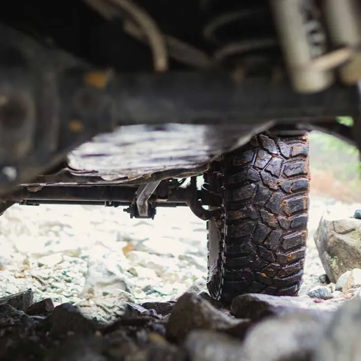 Jeep Underside Showing Wet Tires on Rocks
