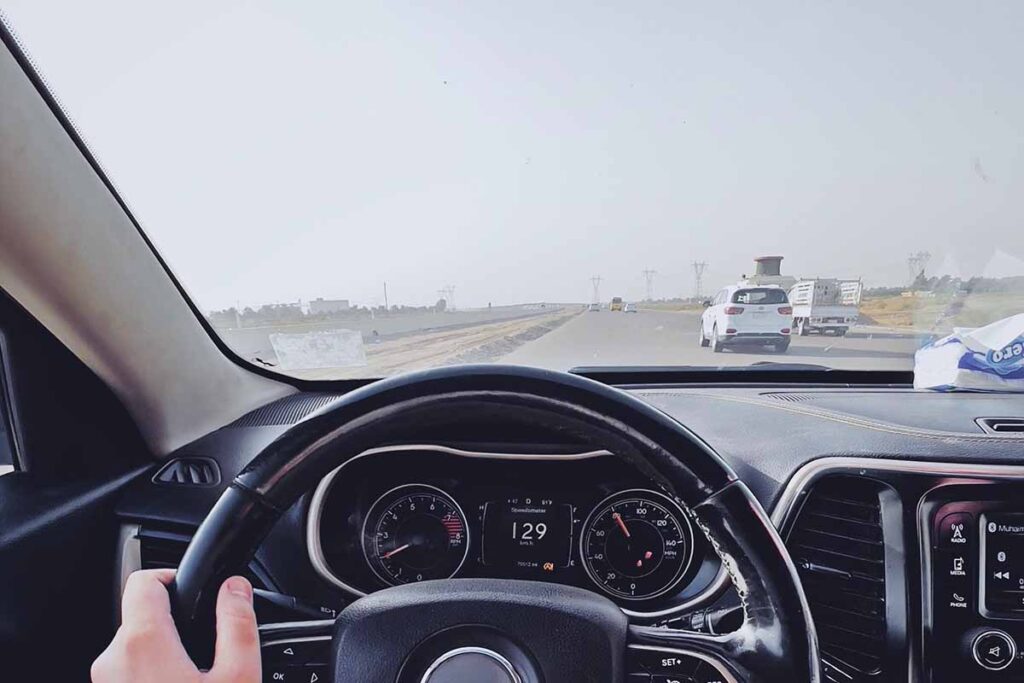 Person Controlling the Steering Wheel of a Vehicle