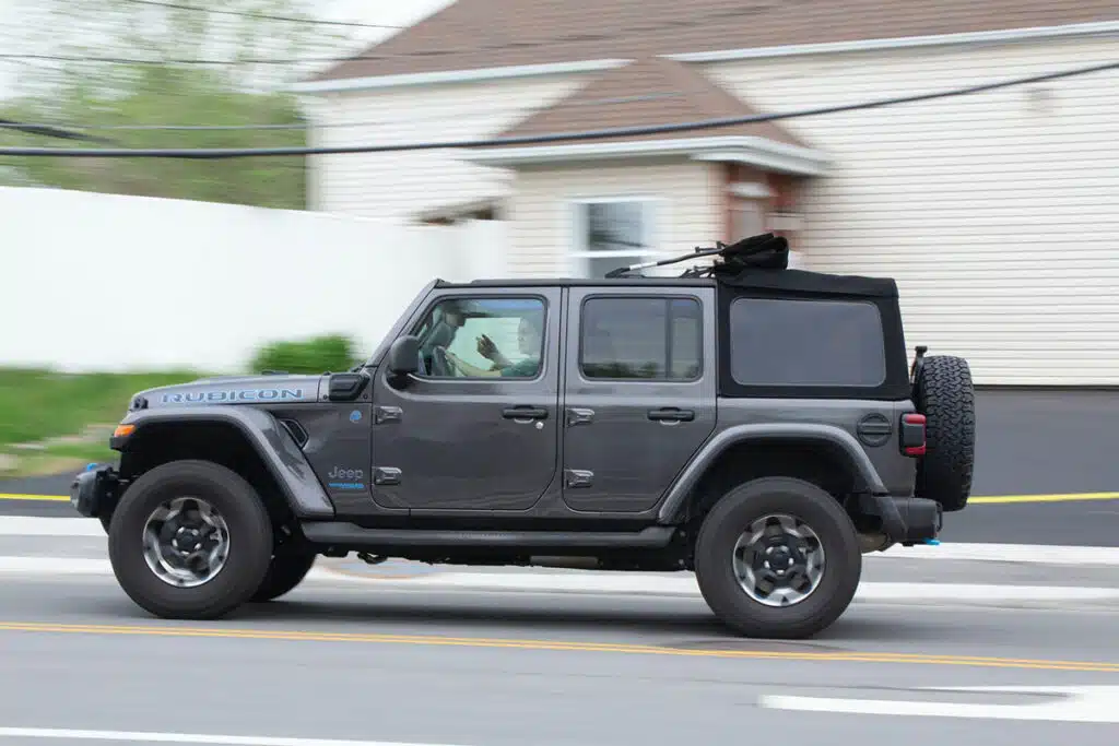 Gray Jeep Wrangler Rubicon Driving Down a Street