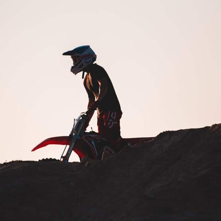 Person Riding Dirt Bike During Sunset
