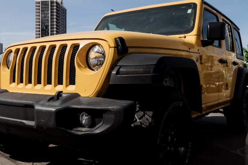 Yellow Jeep Wrangler in a Parking Lot