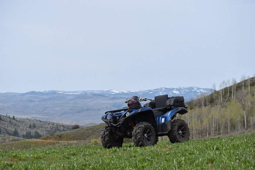 Blue ATV Parked on a Grassy Hill