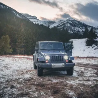 Jeep on Snow-Covered Ground Near Mountain