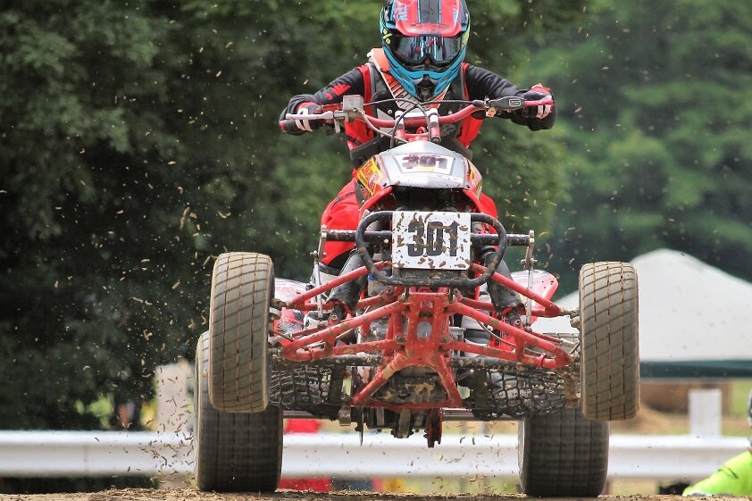 A Person With a Helmet Riding an ATV Quad Bike