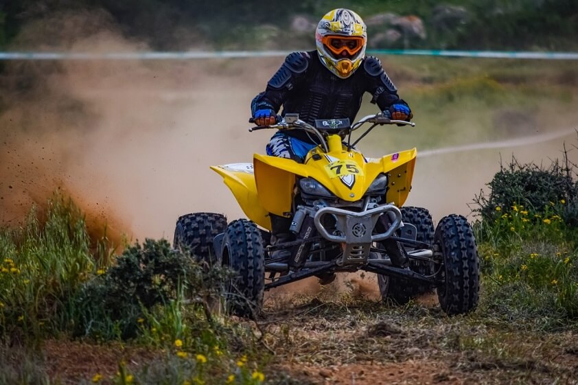 Riding a Yellow ATV on a Dirt Trail