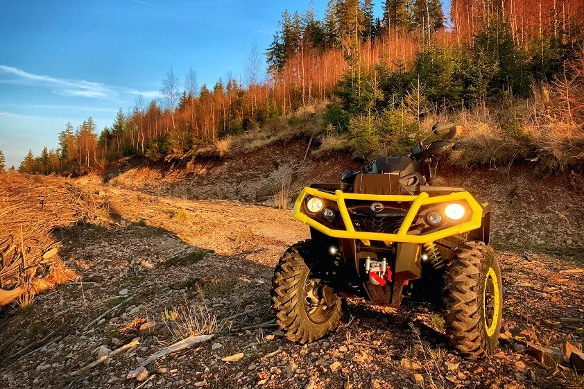 ATV on a Dirt Road With Headlights On