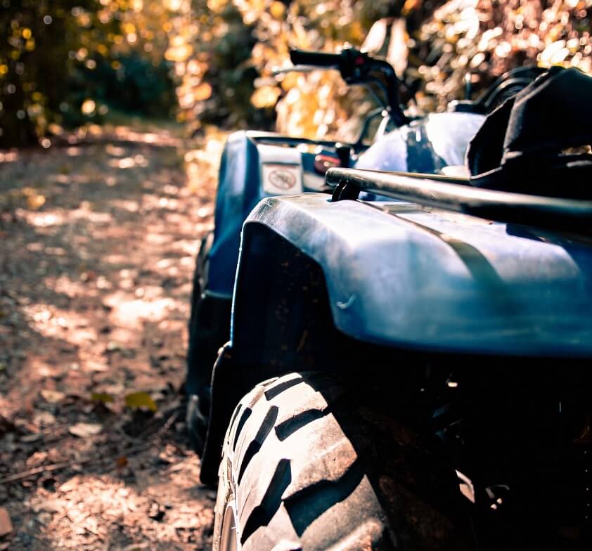 Blue ATV on Dirt Road in Forest