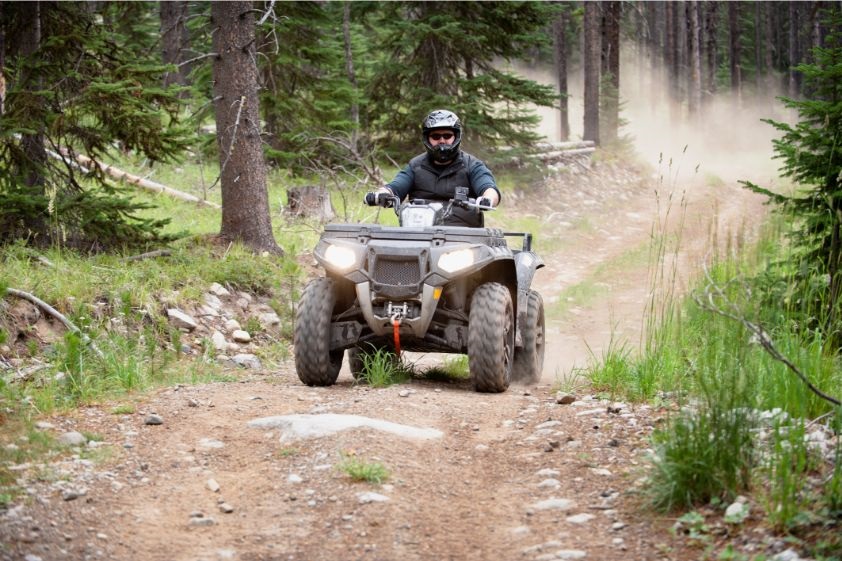 Man Riding ATV on Forest Trail