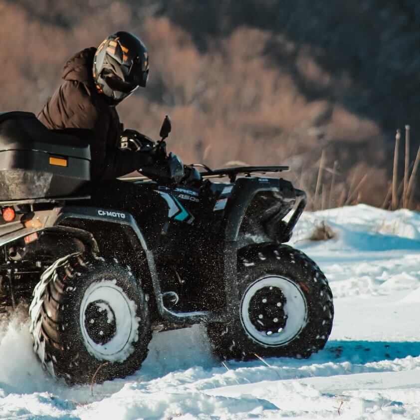 Person Riding ATV in Snow