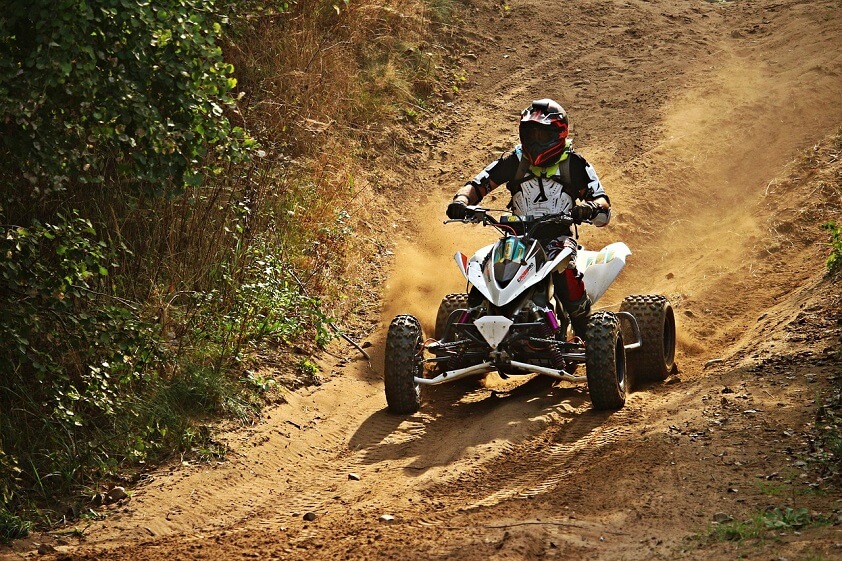 Person Riding White Motocross ATV Quad