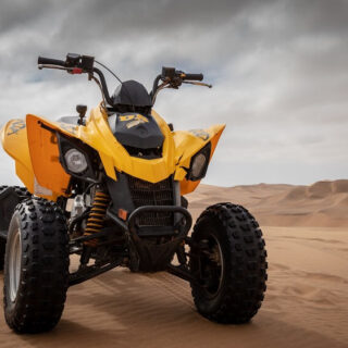 Yellow and Black Can-Am DS 250 ATV on Sand